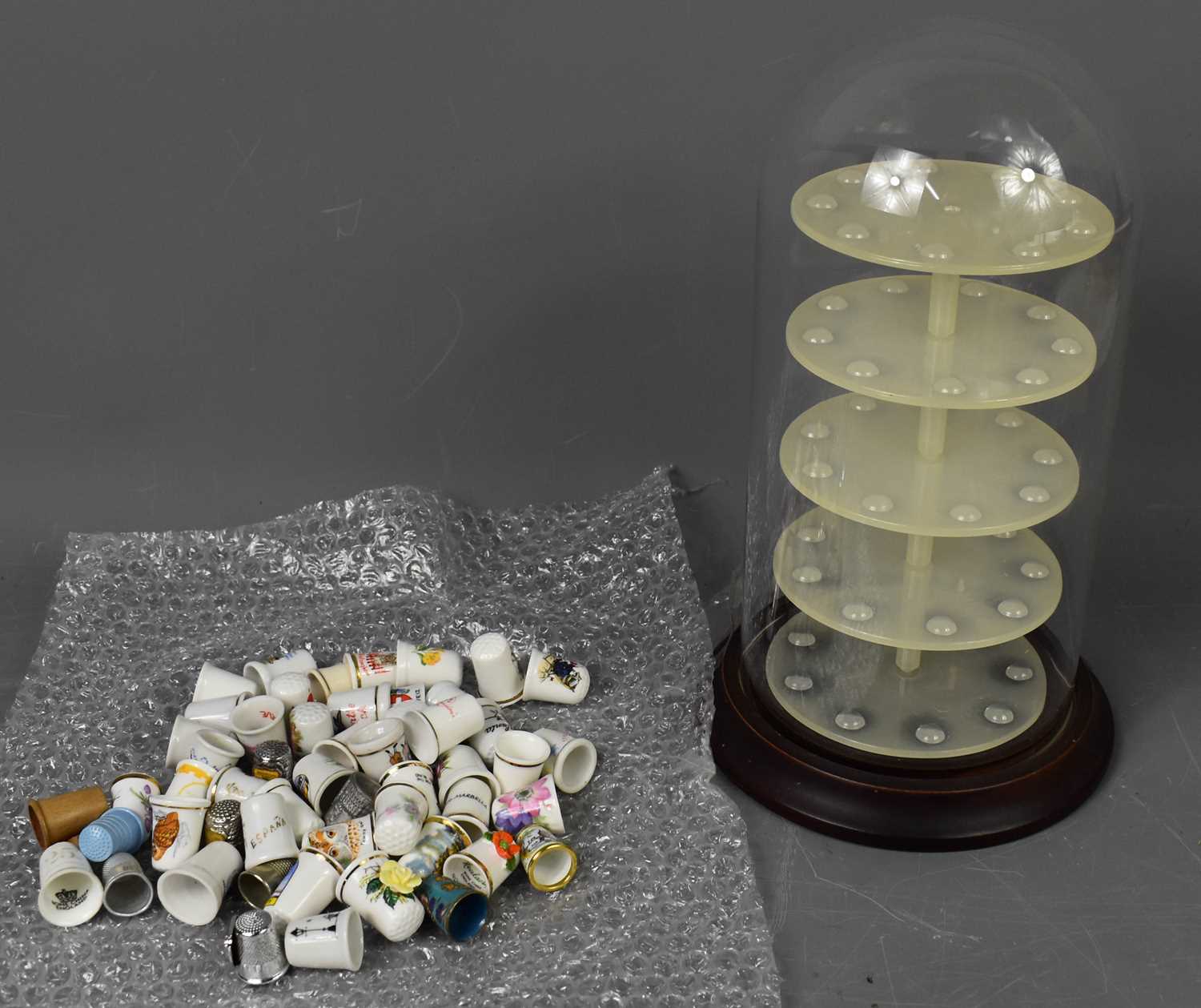 Lot 49 - A glass domed thimble display case together...