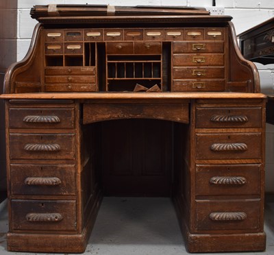 Lot 479 - A 1940s oak roll top desk, the interior fitted...