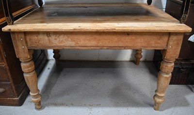 Lot 487 - An antique pine kitchen table raised on turned...