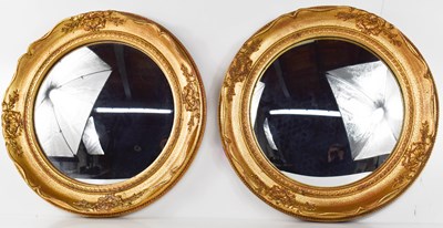 Lot 285 - A pair of 20th century bull's eye mirrors with...