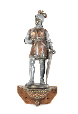 Lot 14 - A vintage metalware wall-mounted knight with a...