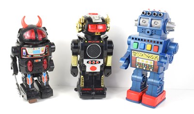 Lot 566 - Three vintage battery operated robots to...