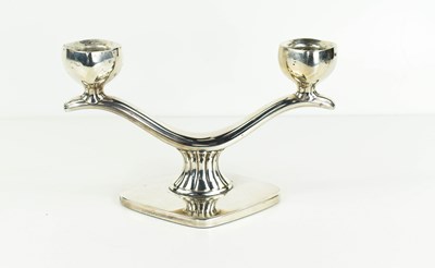 Lot 356 - A white metal double candlestick of curved...