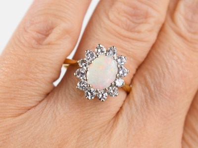 Lot 149 - An 18ct gold, diamond and opal flowerhead ring,...