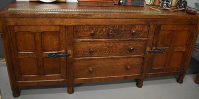 Lot 526 - An Owl Man oak dining suite, comprising a...