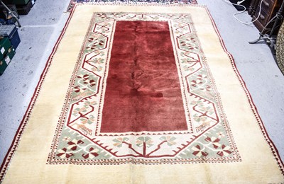 Lot 464 - A large cream ground Turkish wool rug with...