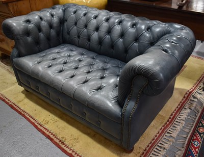 Lot 512 - A blue leather Chesterfield settee of small...