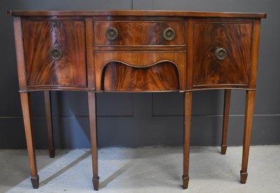 Lot 471 - A reproduction mahogany serpentine sideboard,...