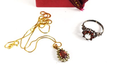 Lot 235 - A 9ct gold pendant set with pear cut garnet...