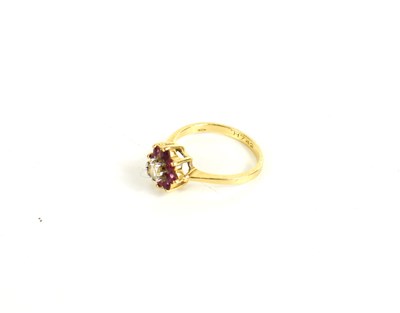 Lot 140 - A 9ct gold diamond and ruby ring, the central...