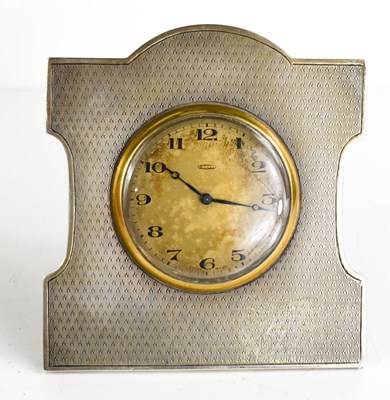 Lot 268 - An Art Deco silver table clock, with engine...