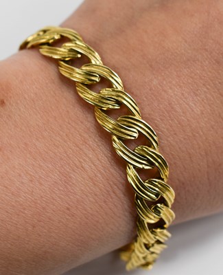 Lot 52 - An 18ct gold flat curb link bracelet with...