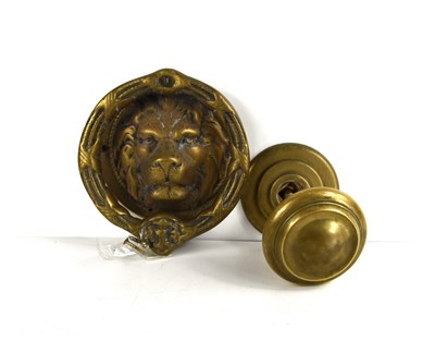 Lot 329 - An antique brass lions head door knocker...