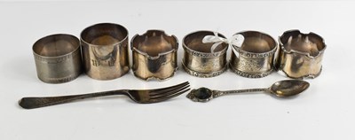 Lot 349 - Four silver napkin rings together with an...