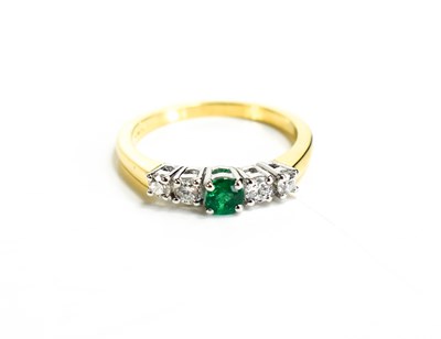 Lot 174 - An 18ct yellow gold, diamond and emerald ring,...