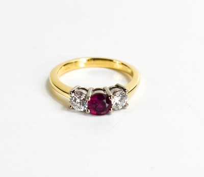 Lot 176 - An 18ct yellow gold, ruby and diamond trilogy...