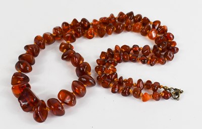 Lot 76 - An amber polished stone beaded rope twist...