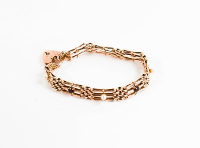 Lot 169 - A 9ct rose gold gate link bracelet, with heart...