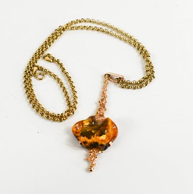 Lot 133 - A 14ct rose gold and amber pendant, of...