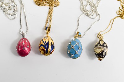 Lot 111 - Four Faberge style egg pendant necklaces, one...