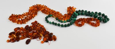 Lot 201 - An amber polished rough cut beaded necklace,...