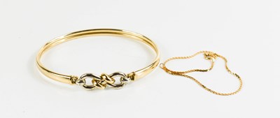 Lot 127 - A 9ct gold bangle with knot clasp, 6.4 by...