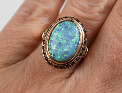 Lot 46 - A 14ct gold, black opal and garnet ring, size...