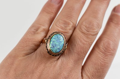 Lot 46 - A 14ct gold, black opal and garnet ring, size...