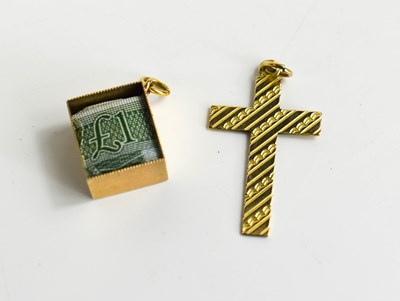 Lot 62 - A 9ct gold cross and charm with a £1 note...