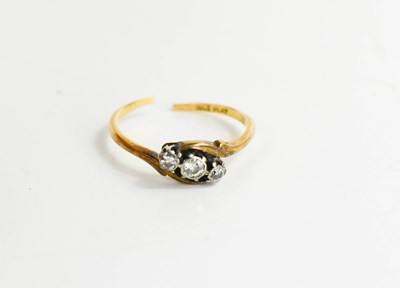 Lot 107 - An 18ct gold and diamond three stone ring,...