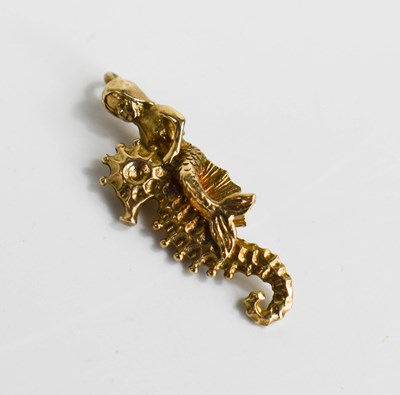 Lot 60 - A 9ct gold charm of a mermaid riding a...