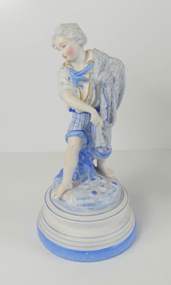 Lot 207 - A 20th century bisque figurine of a boy,...