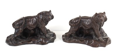 Lot 297 - A pair of bronzed resin tigers, each signed to...