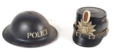 Lot 402 - A WWII police helmet, together with a further...