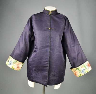 Lot 288 - A Chinese silk ladies jacket in dark blue,...