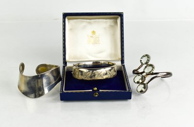 Lot 224 - A group of three silver bangles, comprising a...