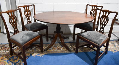 Lot 456 - A Georgian mahogany tilt top oval dining table,...