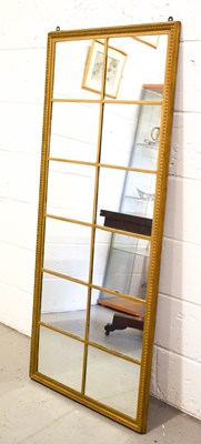 Lot 451 - A large gilt wood hall mirror in the style of...