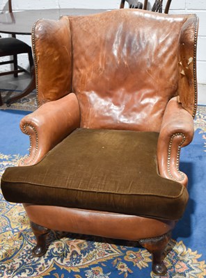 Lot 465 - A 1930s tan leather wingback armchair with...