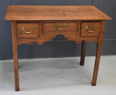 Lot 460 - A 19th century oak lowboy with three drawers,...