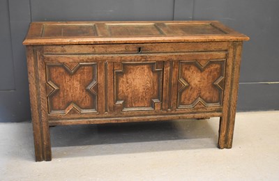 Lot 476 - A 17th century oak coffer, the three panel lid...