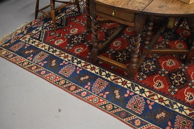 Lot 479 - A Middle Eastern rug with red central ground...