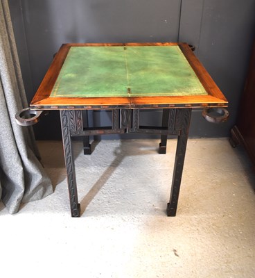 Lot 489 - A Chinese hardwood leather top games table,...