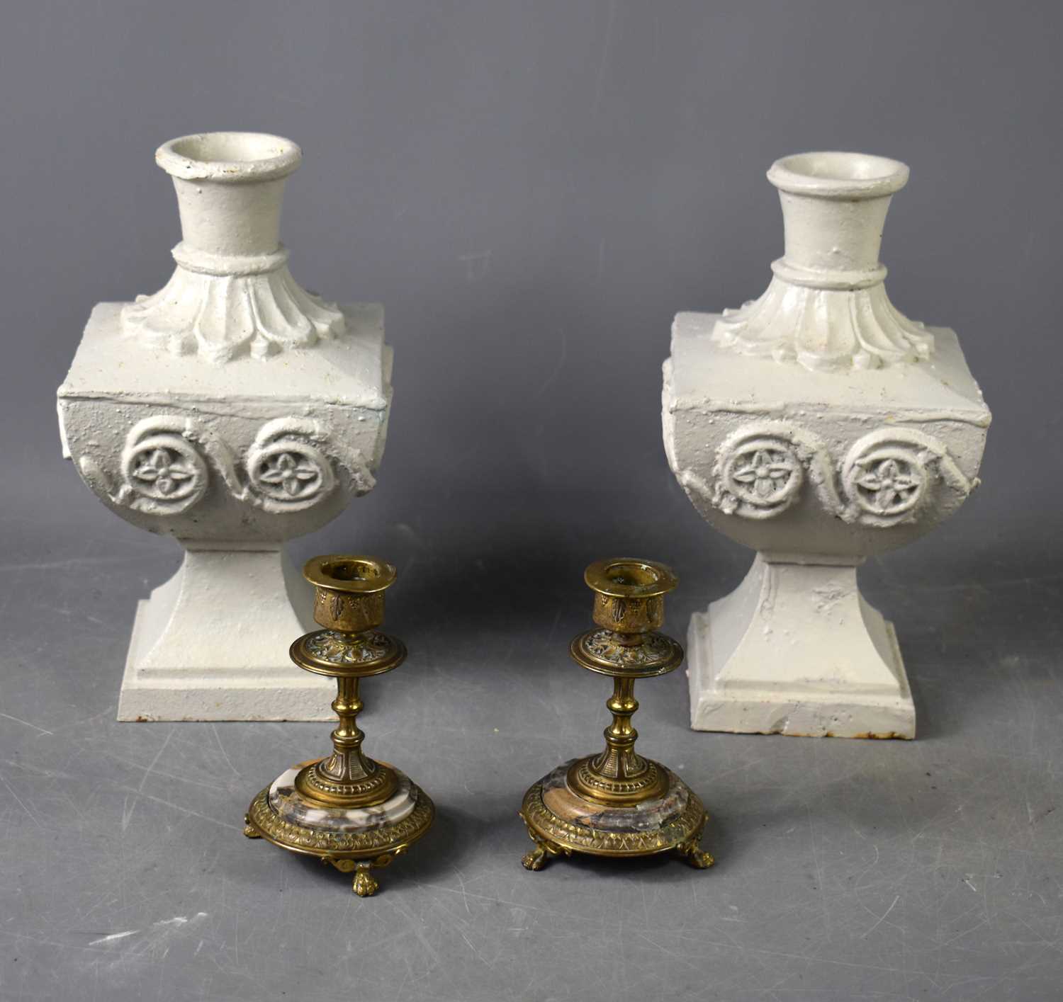 Lot 112 - A pair of painted cast iron candle sticks of...