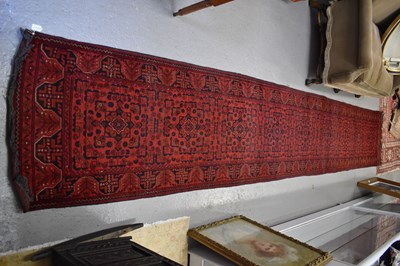 Lot 255 - A very long wool runner, the red ground with...