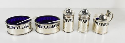 Lot 437 - A silver cruet set with blue glass liners,...