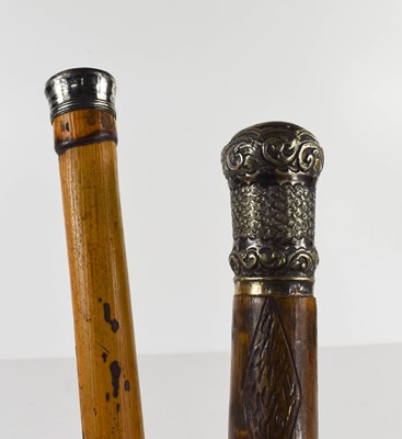 Lot 215 - Two antique walking canes with silver plated...