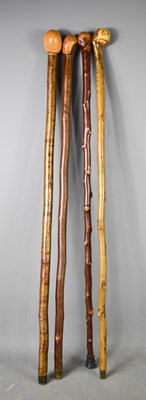 Lot 217 - A group of four vintage walking canes, of...