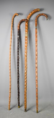 Lot 224 - A group of four knotwood walking sticks, of...