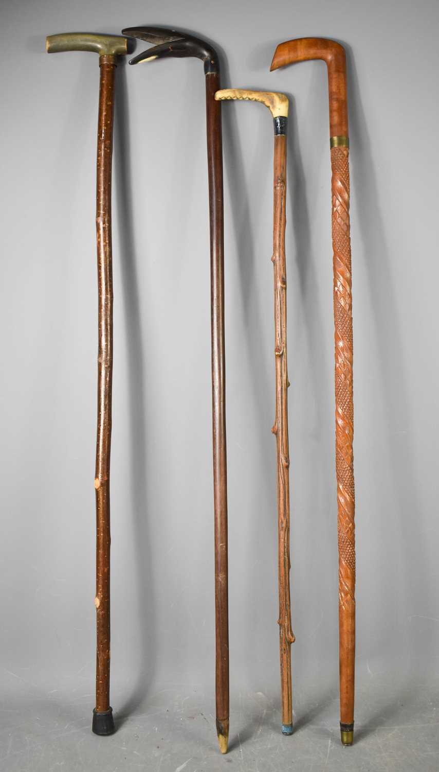 Lot 211 - Four vintage walking canes, three with horn...